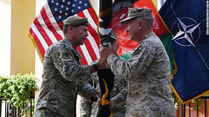 General Austin Miller, the top US commander in Afghanistan, passes the flag of US-led Resolute Support mission to General Kenneth McKenzie, the head of US Central Command, on July 12.