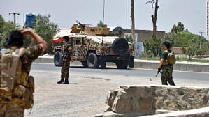Afghan security personnel stand guard as Afghan security forces fight the Taliban in Kandahar on July 9.