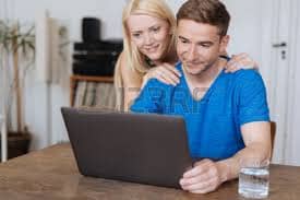A young couple searching the internet for best security cameras