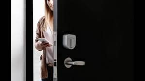 Picture of a woman operating a smart lock with a smartphone