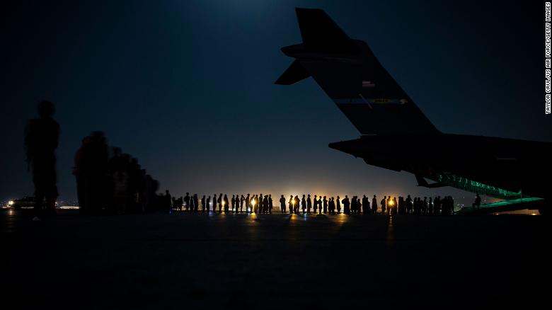 A US Air Force air crew prepares to load evacuees aboard a C-17 Globemaster III transport aircraft at Hamid Karzai International Airport in Kabul on August 21.