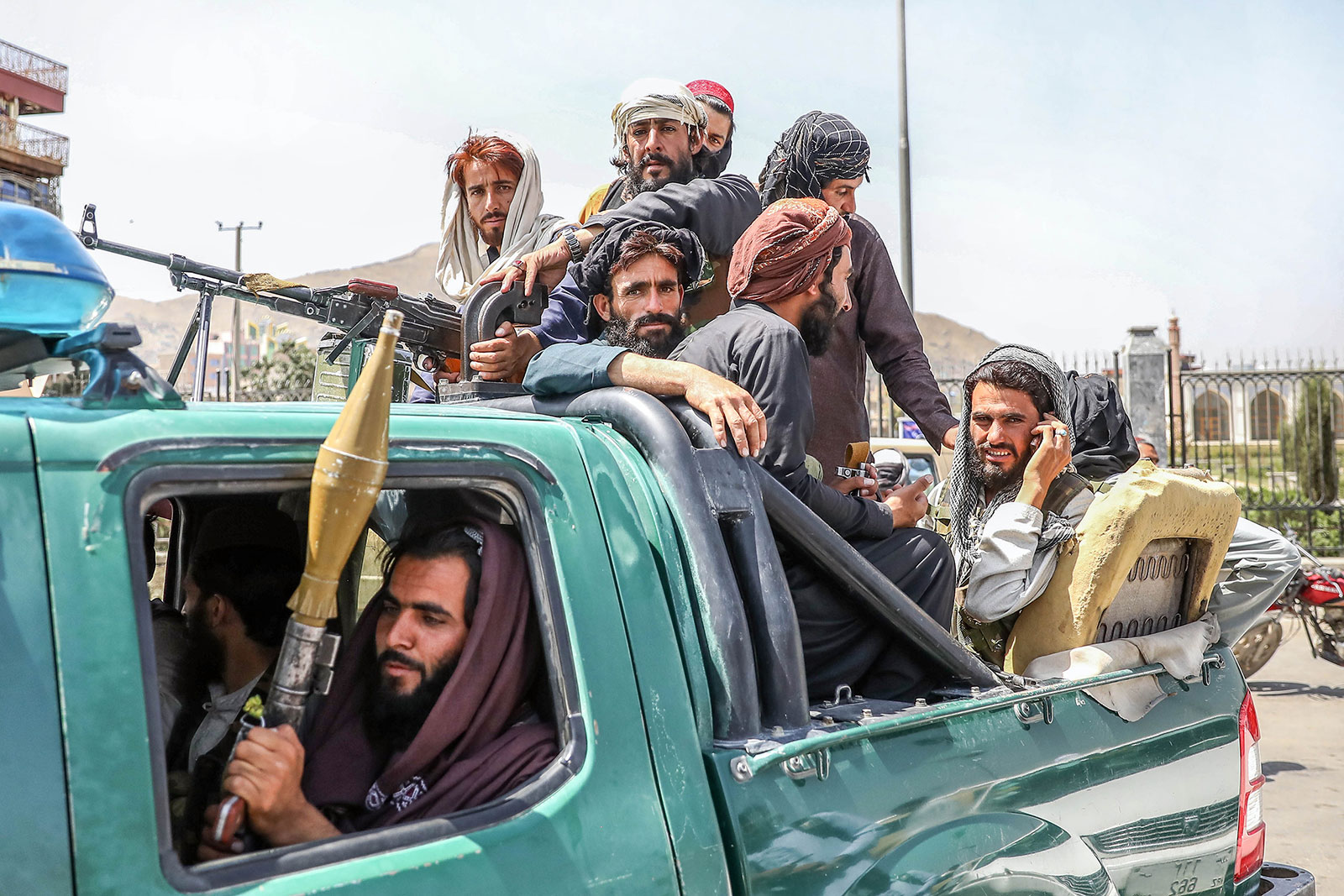 Taliban fighters are seen on the back of a vehicle in Kabul on August 16.