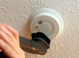 Brushing dust off a smoke detector